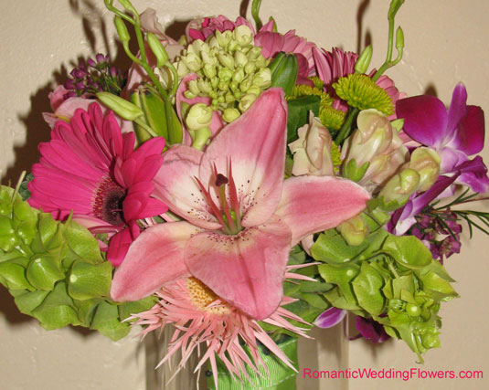 This vibrant bouquet features hot pink and medium pink gerberas green 